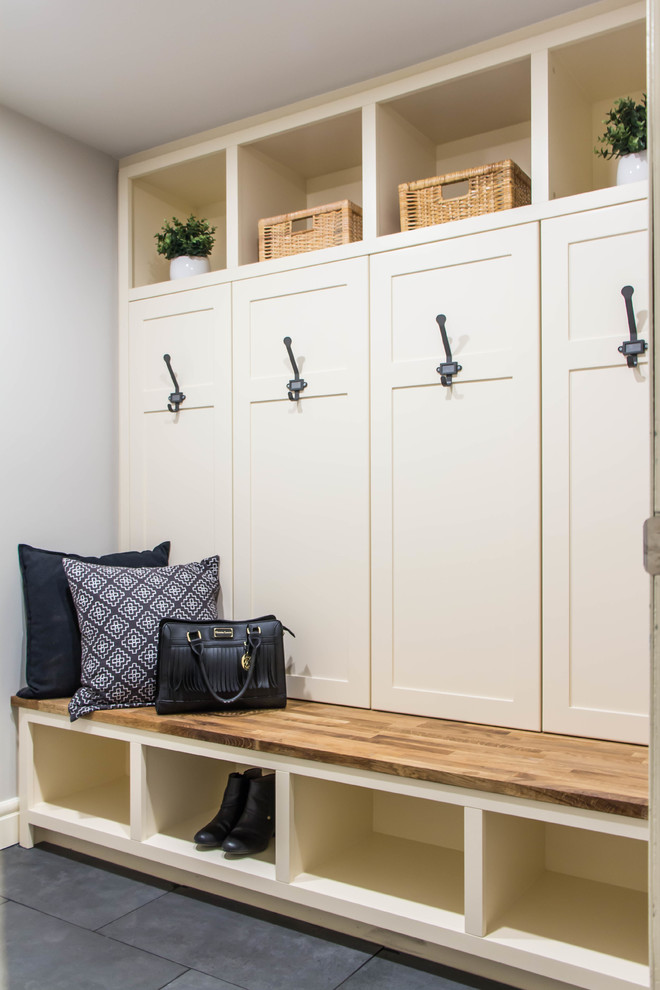 Small country mudroom in Calgary with grey walls, porcelain floors and grey floor.