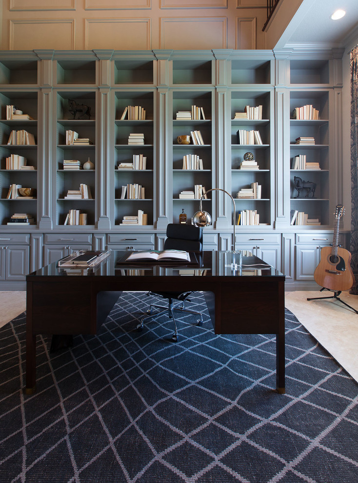 Example of a large transitional freestanding desk home office library design in Orange County