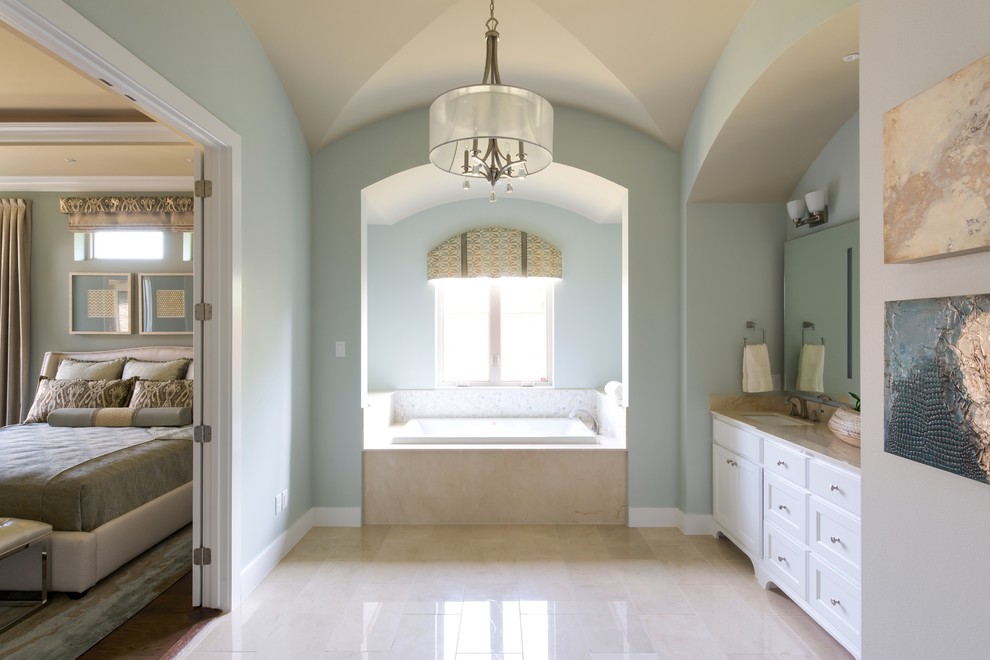 This is an example of a mid-sized country master bathroom in Other with recessed-panel cabinets, white cabinets, an alcove tub, green walls, an undermount sink, marble floors, marble benchtops and a shower/bathtub combo.