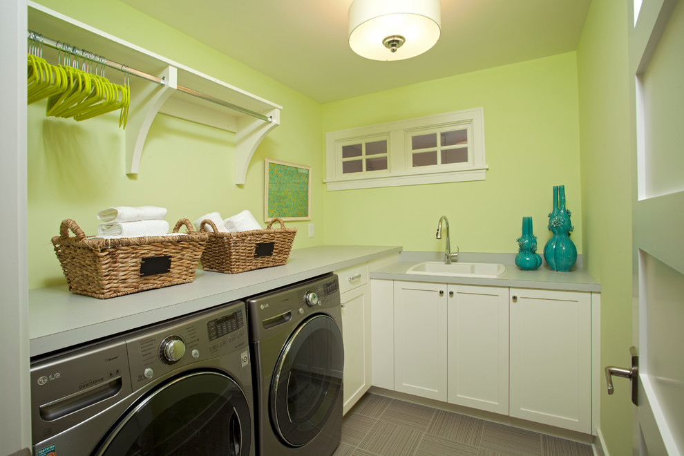 Photo of a beach style laundry room in Minneapolis with a drop-in sink and white cabinets.
