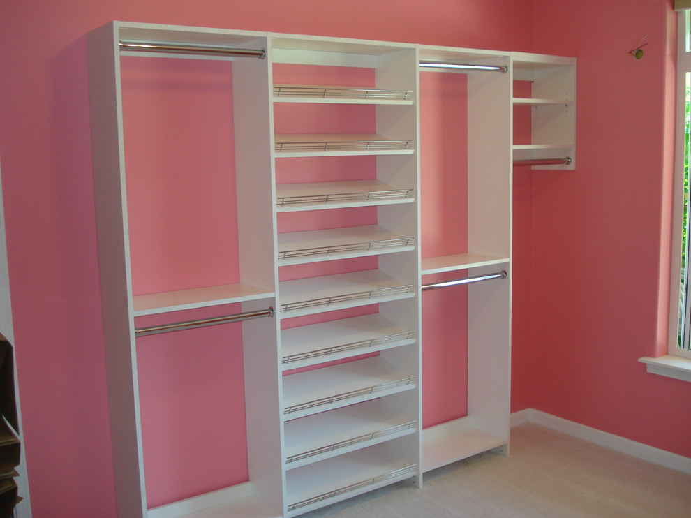 Expansive contemporary women's walk-in wardrobe in Seattle with raised-panel cabinets, white cabinets, carpet and white floor.