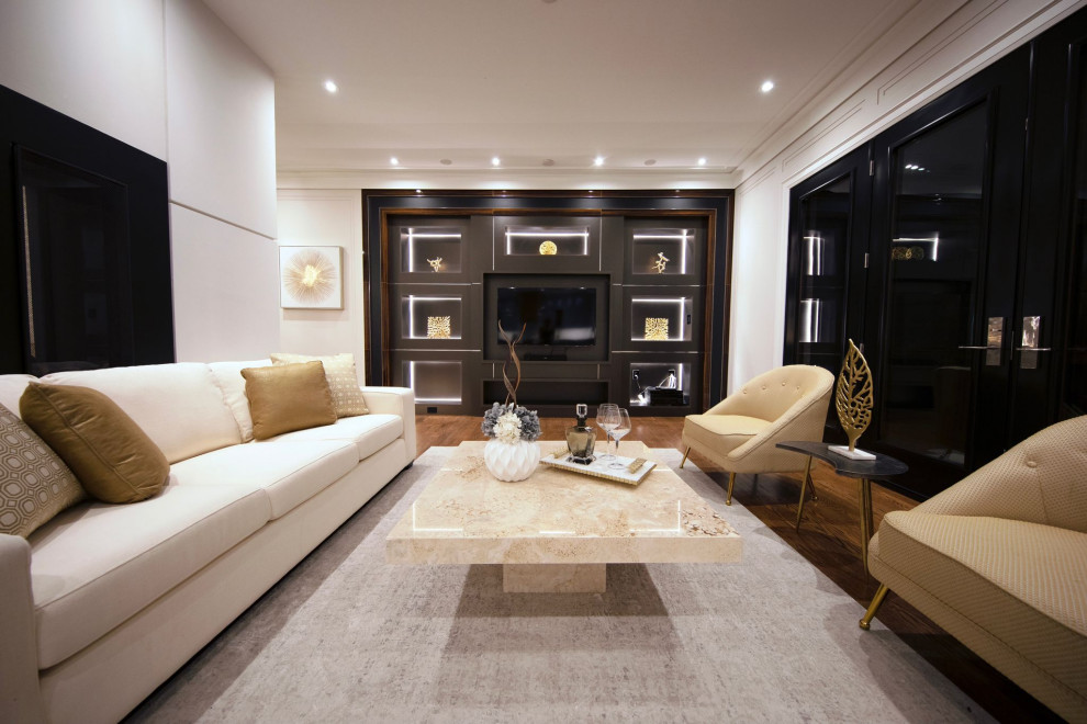 This is an example of a large transitional formal living room in Toronto with black walls, medium hardwood floors, a two-sided fireplace, a plaster fireplace surround, a built-in media wall, brown floor and panelled walls.