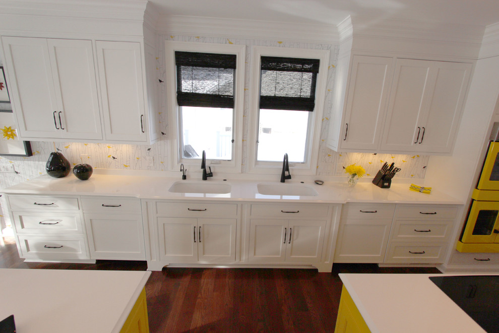 This is an example of an expansive transitional galley eat-in kitchen in Cleveland with an undermount sink, beaded inset cabinets, white cabinets, quartz benchtops, multi-coloured splashback, coloured appliances, medium hardwood floors and multiple islands.