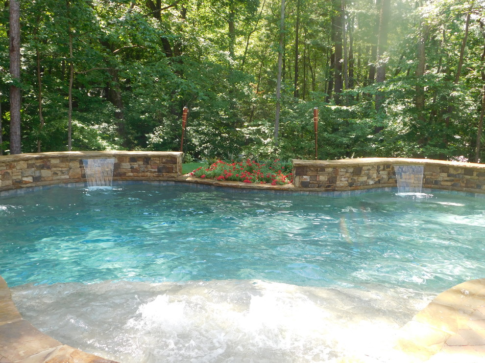 Design ideas for a mid-sized country backyard custom-shaped natural pool in Atlanta with a hot tub and brick pavers.