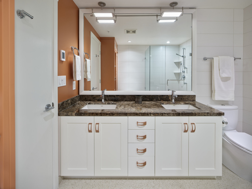 Small eclectic master bathroom in Vancouver with shaker cabinets, orange cabinets, a corner shower, a two-piece toilet, white tile, ceramic tile, white walls, ceramic floors, an undermount sink, marble benchtops, beige floor, a hinged shower door, brown benchtops, a shower seat, a double vanity and a built-in vanity.
