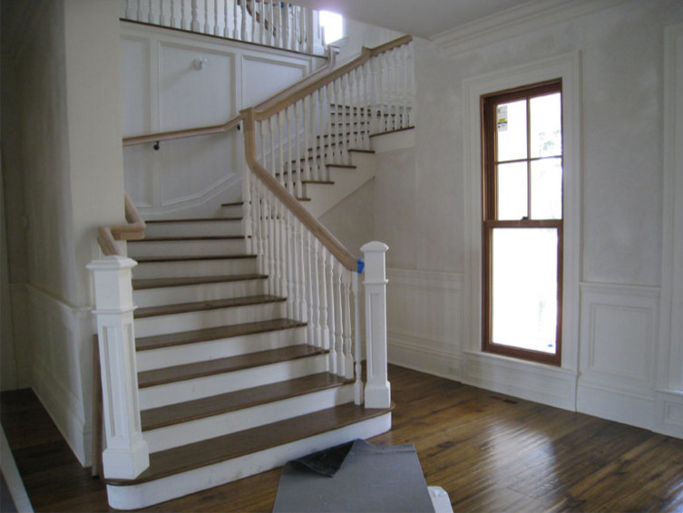 Design ideas for a mid-sized traditional wood curved staircase in New York with painted wood risers.