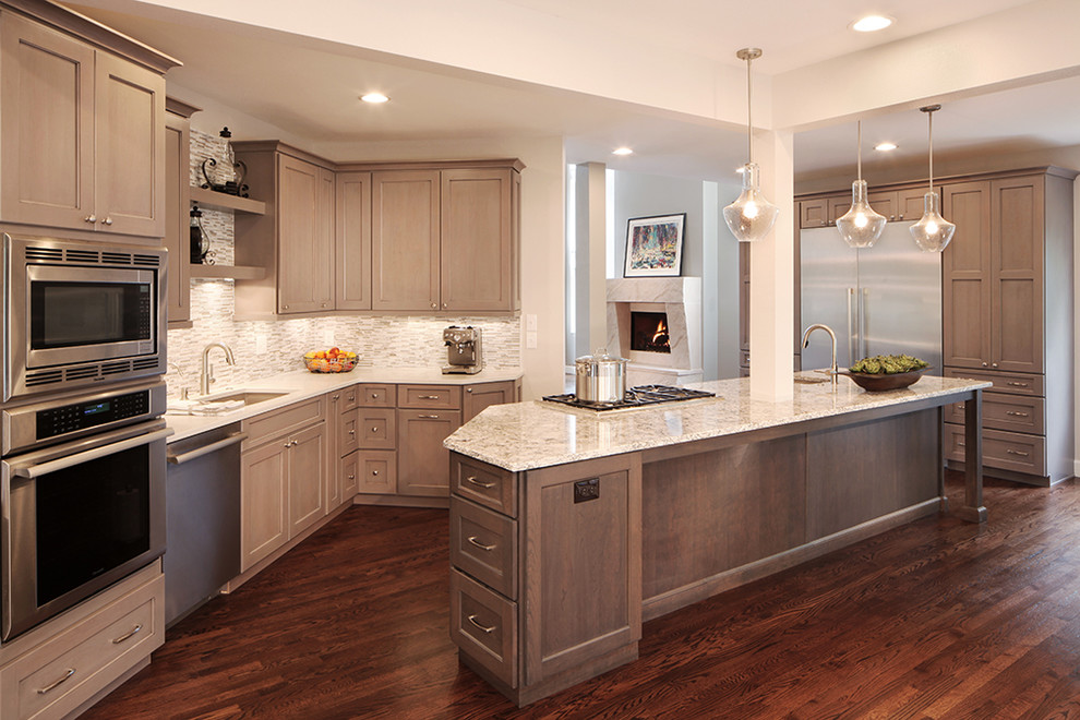 Large transitional medium tone wood floor kitchen photo in Denver with an undermount sink, gray cabinets, quartz countertops, gray backsplash, mosaic tile backsplash, stainless steel appliances and an island