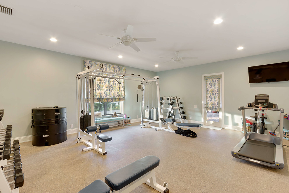 This is an example of a transitional home gym in Miami with green walls and beige floor.