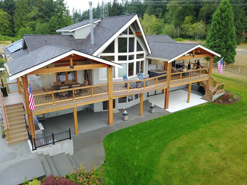 Inspiration for a large country backyard deck in Seattle with a roof extension and an outdoor kitchen.