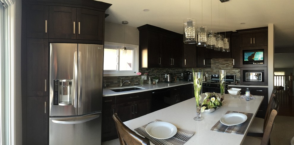 Enclosed kitchen - mid-sized transitional l-shaped enclosed kitchen idea in Toronto with an undermount sink, shaker cabinets, dark wood cabinets, quartz countertops, multicolored backsplash, glass tile backsplash, stainless steel appliances and an island