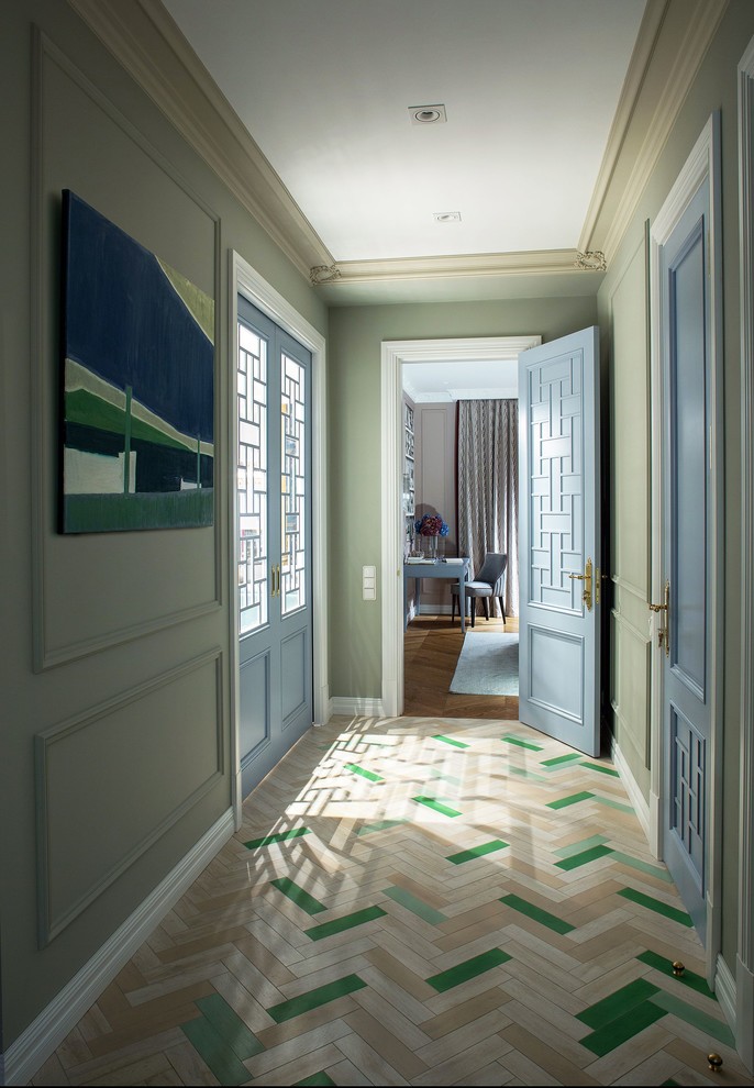 Design ideas for a mid-sized eclectic hallway with green walls, light hardwood floors and beige floor.