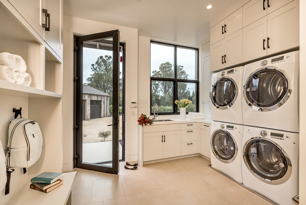 Inspiration for a transitional laundry room in San Francisco with an undermount sink, shaker cabinets, white cabinets, white walls and a side-by-side washer and dryer.