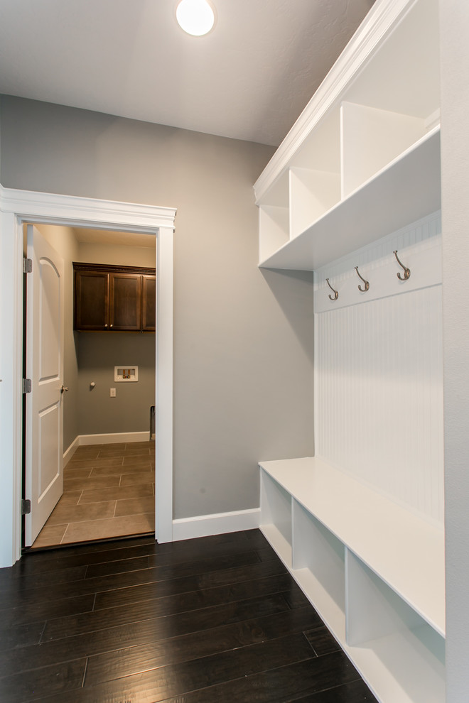Inspiration for a small transitional dark wood floor mudroom remodel in Seattle with gray walls and a white front door
