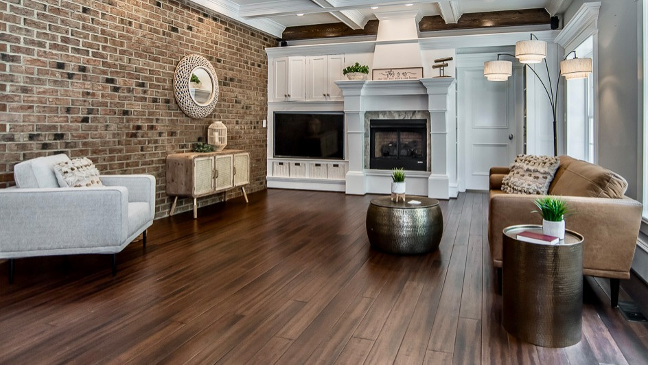 Photo of a large arts and crafts open concept living room in Raleigh with a standard fireplace, a built-in media wall, coffered and brick walls.