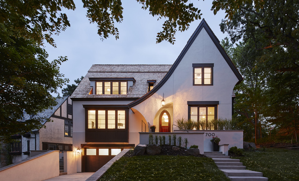 Inspiration for a transitional two-storey stucco white exterior in Minneapolis with a gable roof.