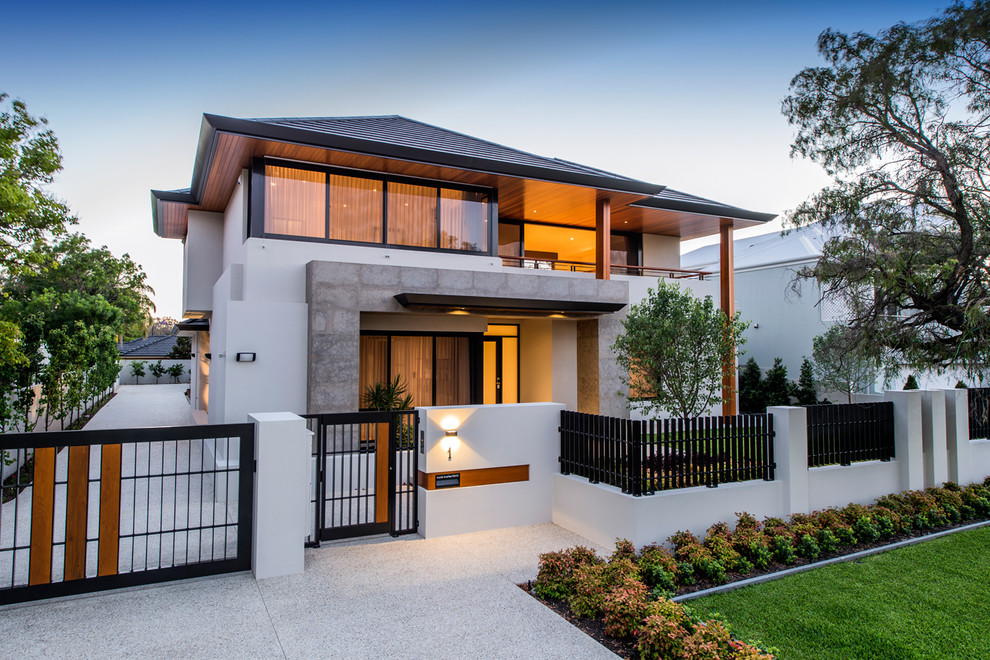 This is an example of a large contemporary two-storey stucco white exterior in Perth with a hip roof.