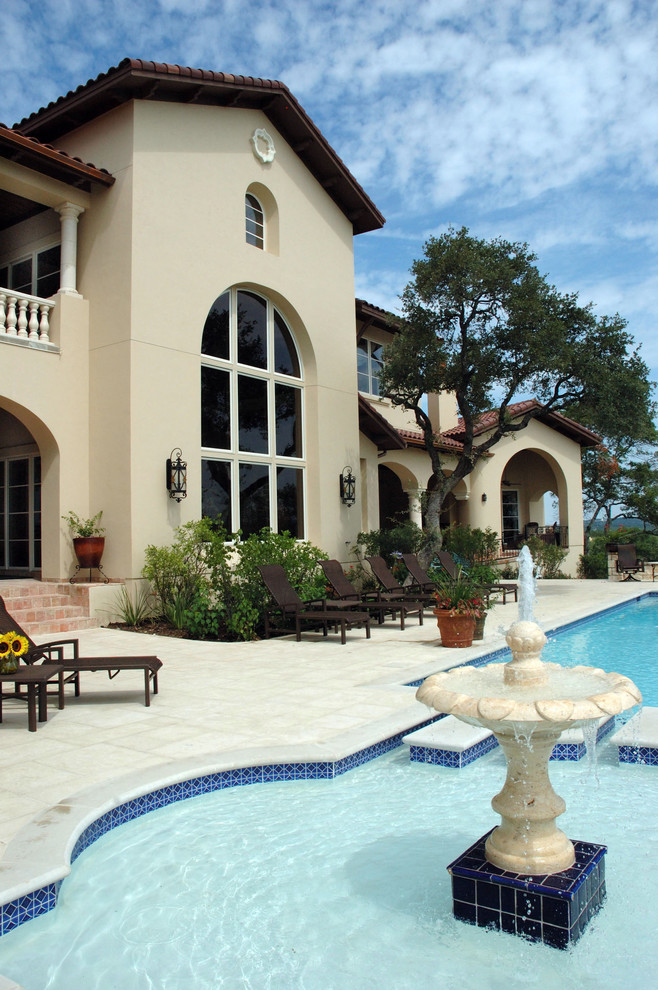 Mediterranean patio in Austin with a water feature.