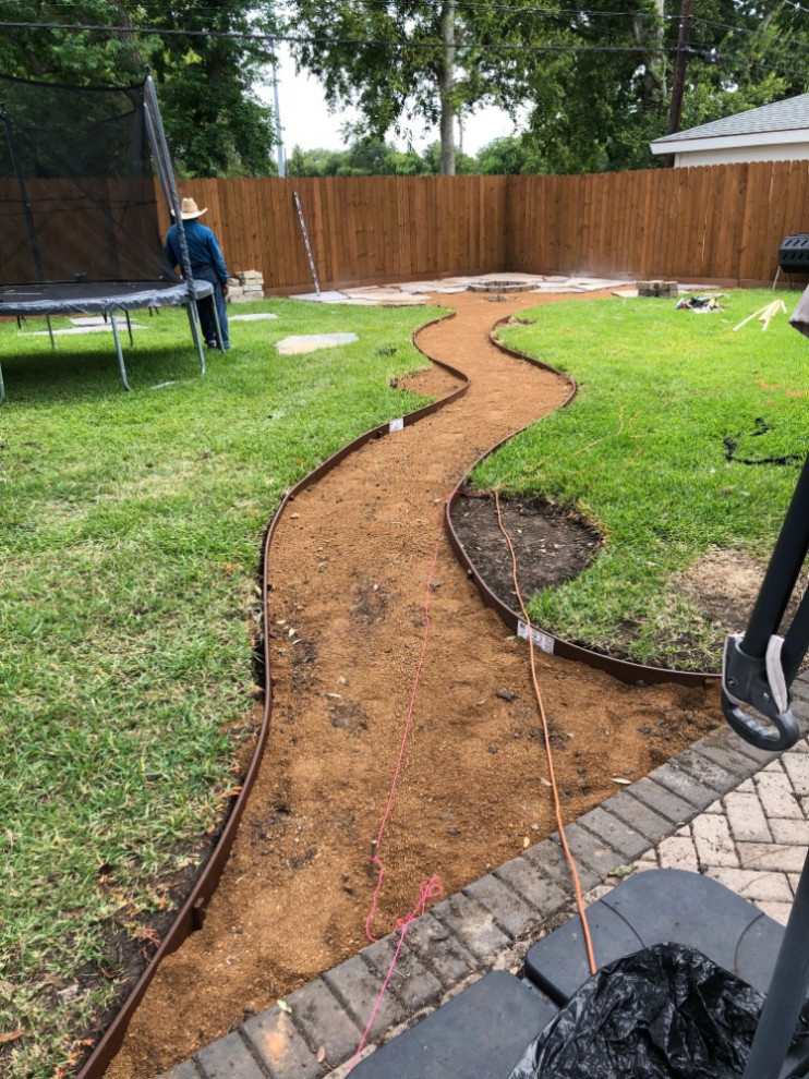 Backyard flagstone walking path with firepit and seating area