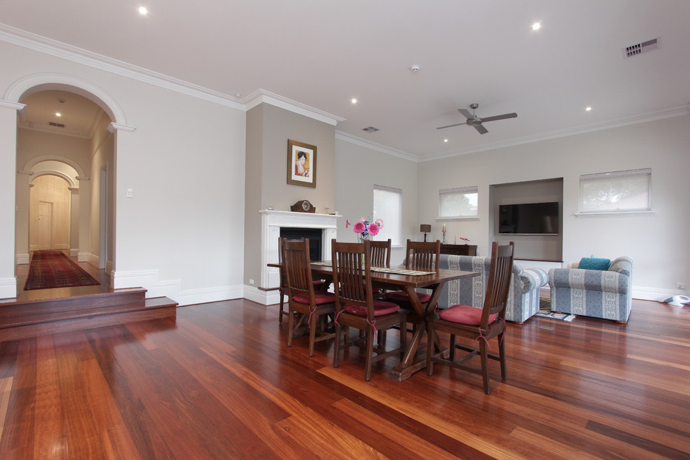 Large traditional kitchen/dining combo in Perth with beige walls, dark hardwood floors, a standard fireplace and a wood fireplace surround.