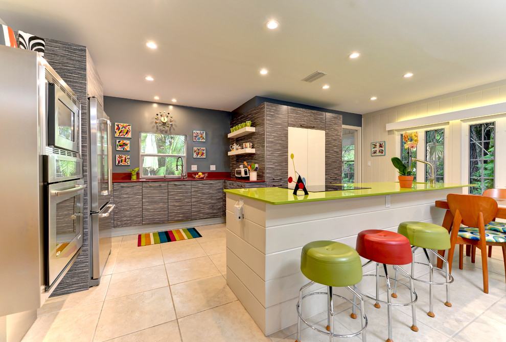 Photo of a large eclectic u-shaped eat-in kitchen in Other with an undermount sink, flat-panel cabinets, grey cabinets, solid surface benchtops, stainless steel appliances, ceramic floors, with island, beige floor and green benchtop.