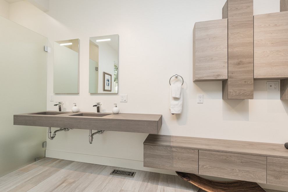 Inspiration for a large modern master bathroom in San Francisco with open cabinets, white cabinets, white walls, an integrated sink and brown benchtops.