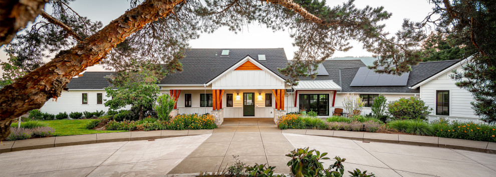 Coburg Farmhouse Remodel - Inspiration for a huge white one-story concrete fiberboard and clapboard gable roof remodel with a shingle roof and a gray roof