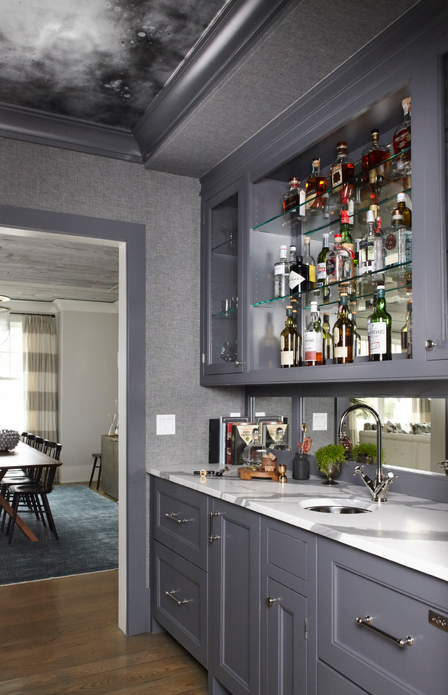 Inspiration for a traditional single-wall wet bar in New York with grey cabinets, mirror splashback, brown floor, an undermount sink, dark hardwood floors and recessed-panel cabinets.