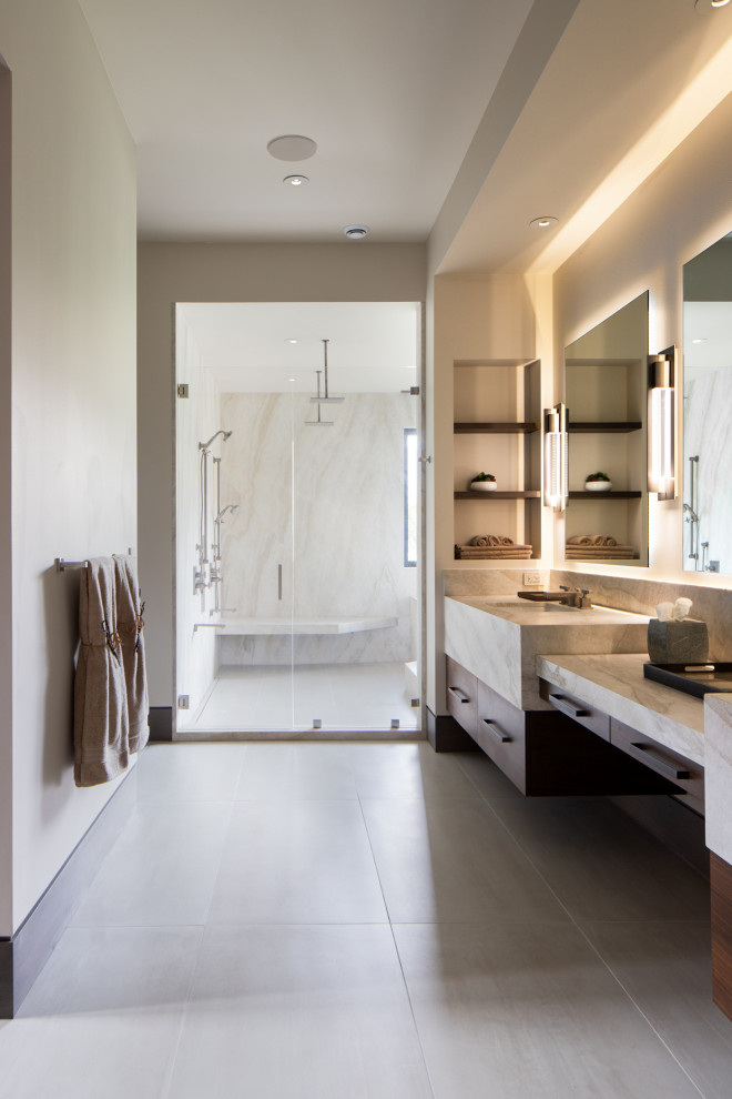 Design ideas for an expansive world-inspired ensuite wet room bathroom in Salt Lake City with flat-panel cabinets, brown cabinets, a japanese bath, beige walls, porcelain flooring, a submerged sink, quartz worktops, beige floors, a hinged door, beige worktops, double sinks and a built in vanity unit.