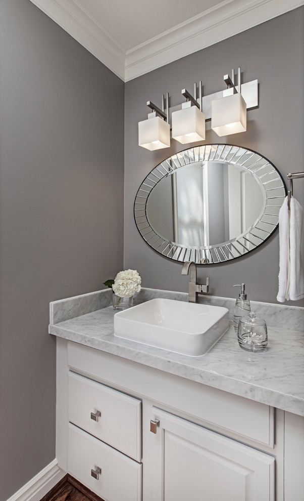 This is an example of a small transitional powder room in Detroit with a vessel sink, raised-panel cabinets, grey cabinets, marble benchtops and grey walls.