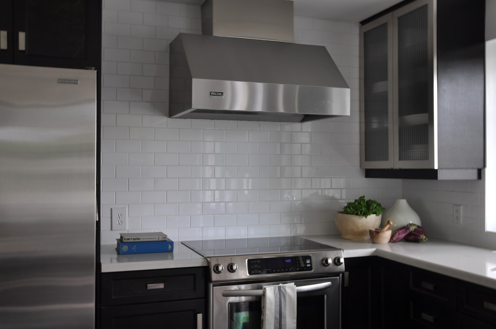 Inspiration for a mid-sized transitional l-shaped limestone floor eat-in kitchen remodel in Toronto with an undermount sink, shaker cabinets, dark wood cabinets, quartzite countertops, white backsplash, cement tile backsplash, stainless steel appliances and an island