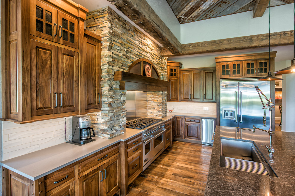 Inspiration for a large rustic l-shaped open concept kitchen remodel with raised-panel cabinets, medium tone wood cabinets and an island