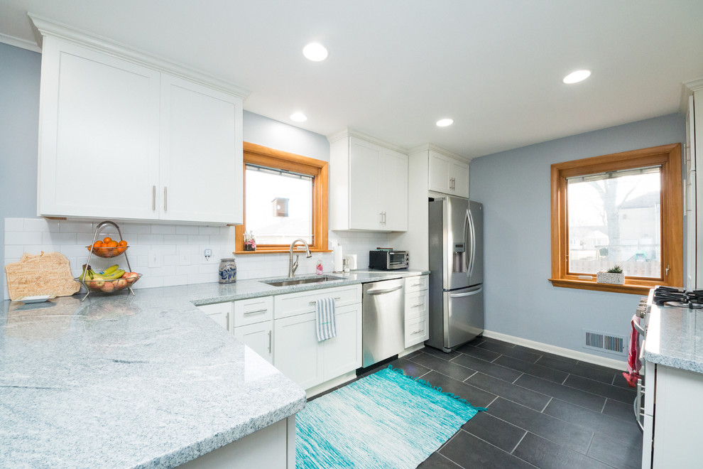 Mid-sized transitional l-shaped eat-in kitchen photo in Columbus with an undermount sink, shaker cabinets, white cabinets, granite countertops, white backsplash, subway tile backsplash and stainless steel appliances