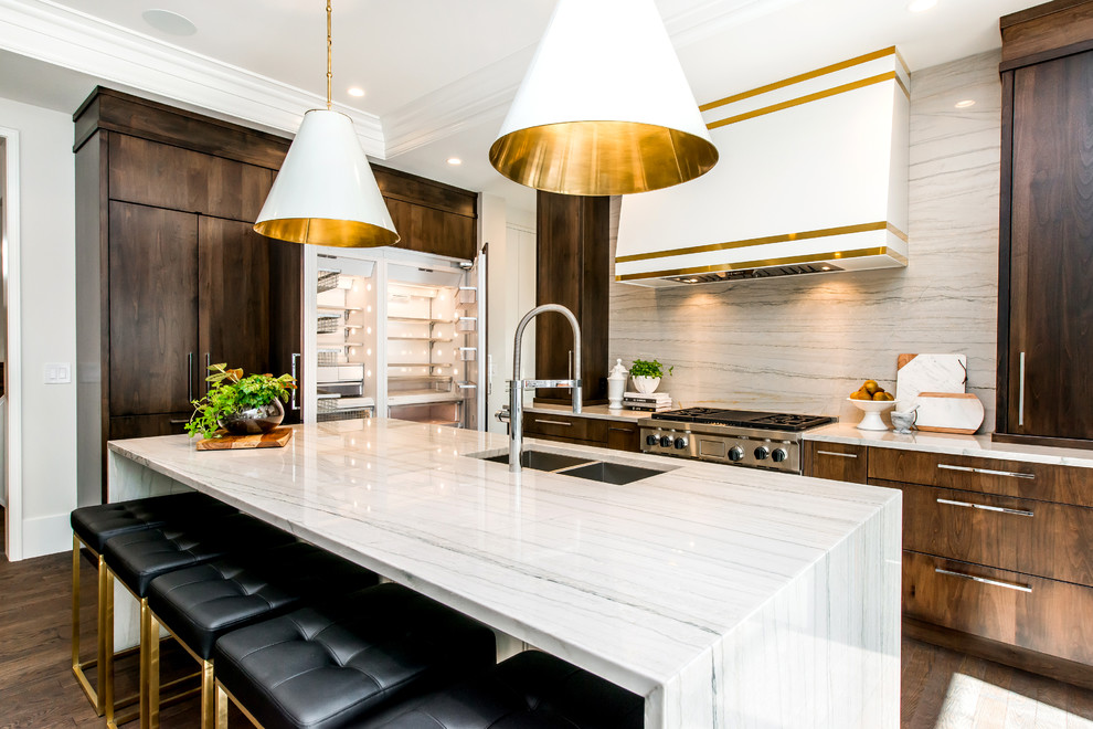 Inspiration for a large transitional l-shaped medium tone wood floor kitchen pantry remodel in Calgary with a double-bowl sink, flat-panel cabinets, marble countertops, white backsplash, stone slab backsplash, paneled appliances and an island