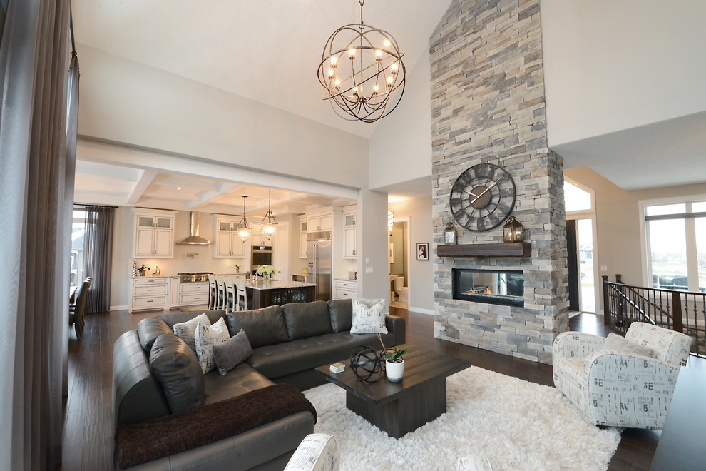 Photo of a mid-sized contemporary formal open concept living room in Edmonton with grey walls, dark hardwood floors, a two-sided fireplace, a stone fireplace surround and a wall-mounted tv.