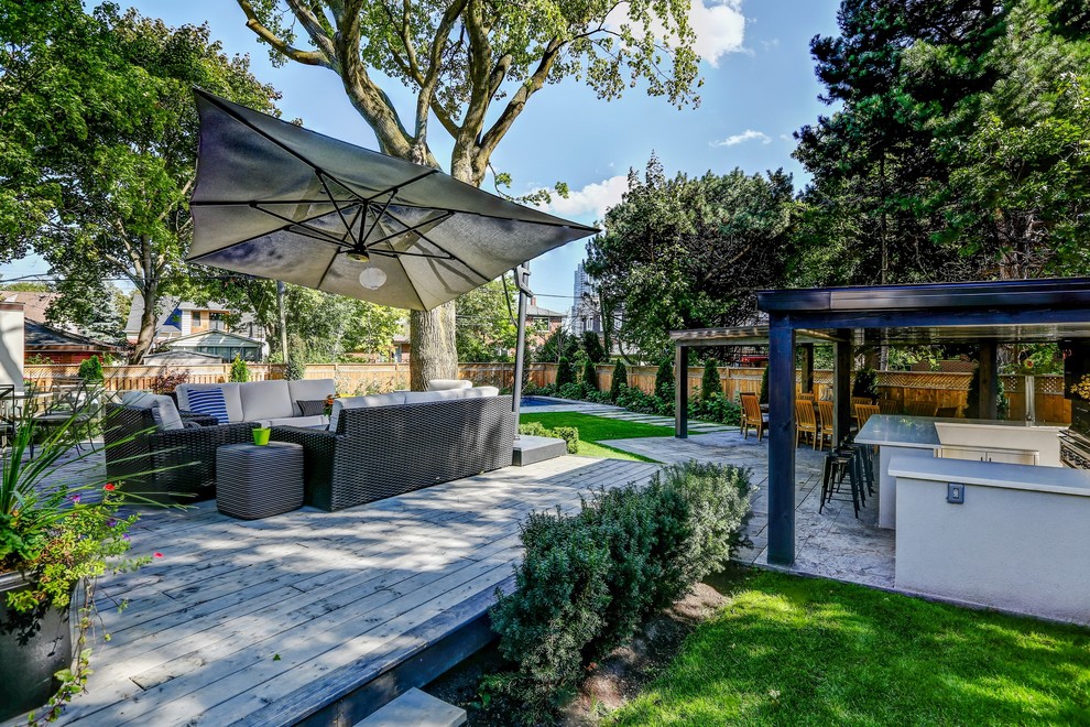 Inspiration for a mid-sized transitional backyard stamped concrete and rectangular pool house remodel in Toronto