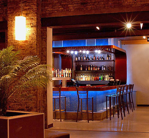 Photo of a large contemporary home bar in New York.