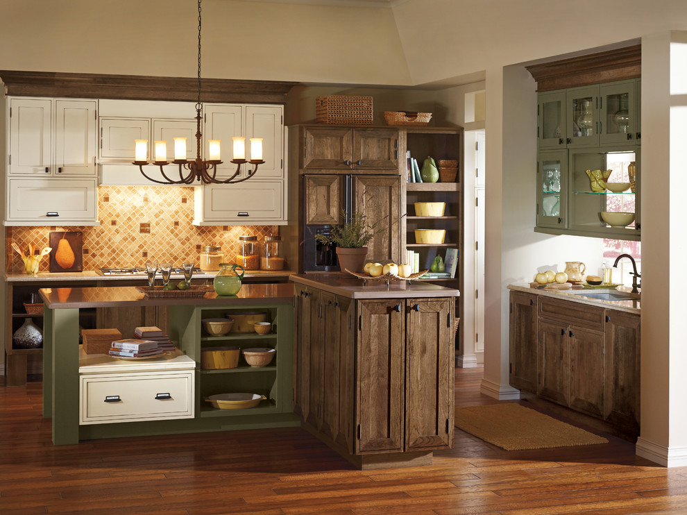 Example of a mid-sized mountain style l-shaped medium tone wood floor open concept kitchen design in Boston with recessed-panel cabinets, medium tone wood cabinets, brown backsplash, two islands, an undermount sink, granite countertops and mosaic tile backsplash