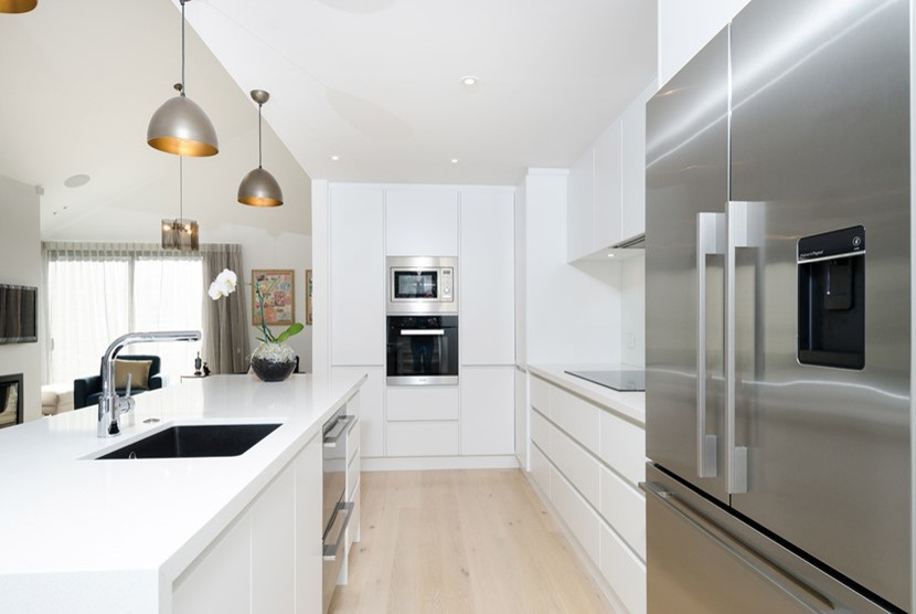 This is an example of a scandinavian kitchen in Auckland with light hardwood floors.