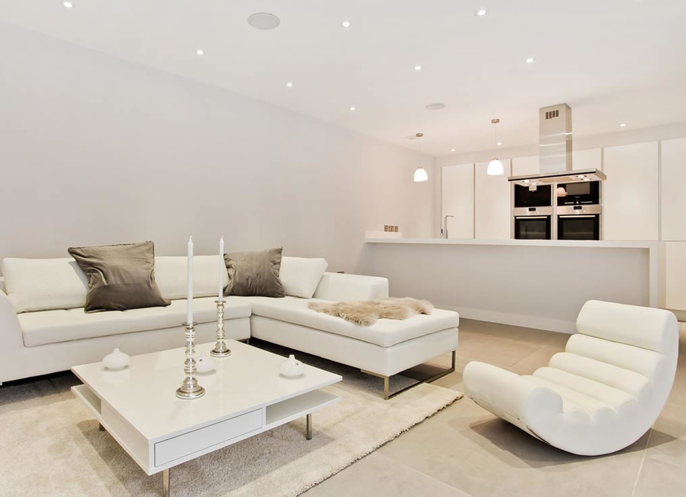 Inspiration for a contemporary formal open plan living room in London with white walls and light hardwood flooring.