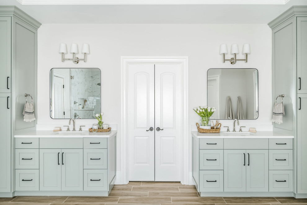 Photo of a large transitional master bathroom in Charlotte with shaker cabinets, green cabinets, grey walls, porcelain floors, engineered quartz benchtops, brown floor, white benchtops, a built-in vanity and a double vanity.