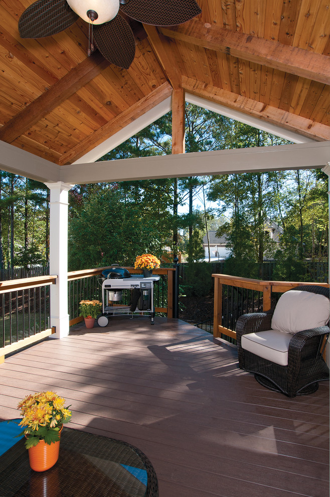 Design ideas for a mid-sized backyard deck in Atlanta with a roof extension.