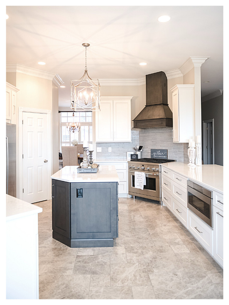 This is an example of a large transitional u-shaped eat-in kitchen in Other with a double-bowl sink, shaker cabinets, white cabinets, quartzite benchtops, grey splashback, ceramic splashback, stainless steel appliances, marble floors, with island, beige floor and white benchtop.