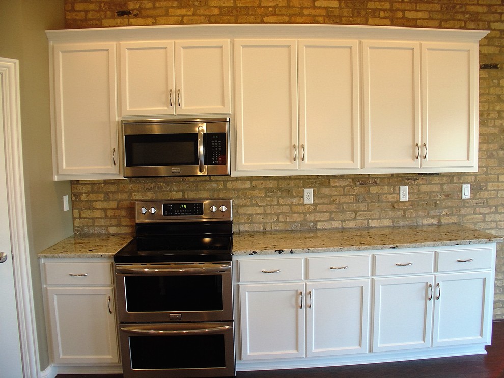 Open concept kitchen - large medium tone wood floor open concept kitchen idea with an island