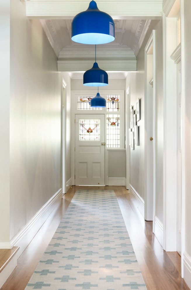 Inspiration for a hallway in Sydney with grey walls and light hardwood floors.