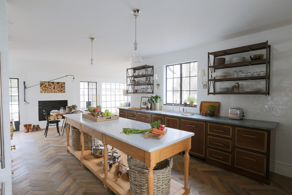 Design ideas for an eclectic eat-in kitchen in Chicago with subway tile splashback, an undermount sink, flat-panel cabinets, dark wood cabinets and white splashback.