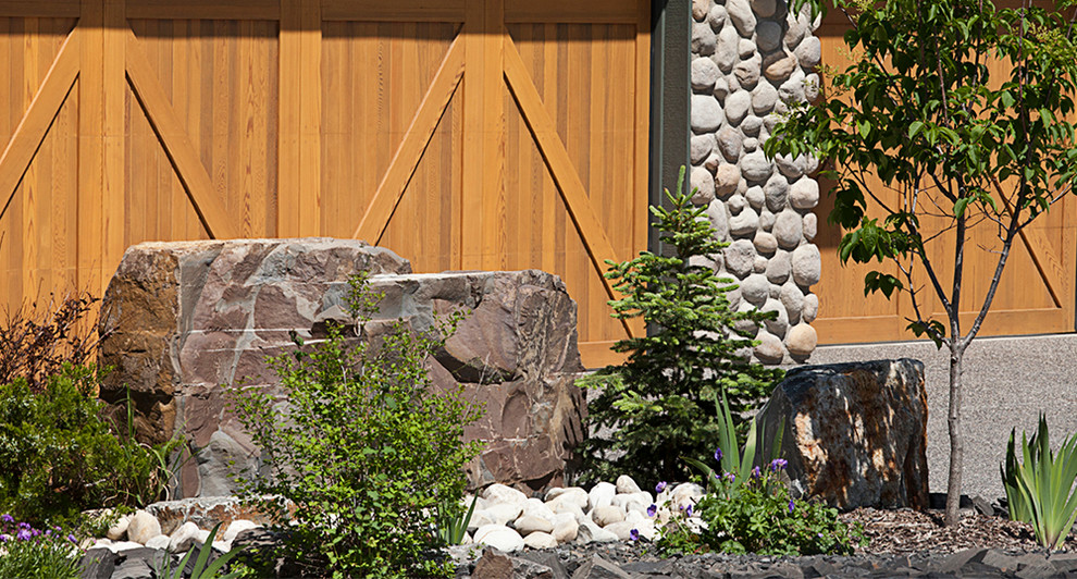 This is an example of a large rustic drought-tolerant and full sun front yard stone garden path in Calgary for summer.