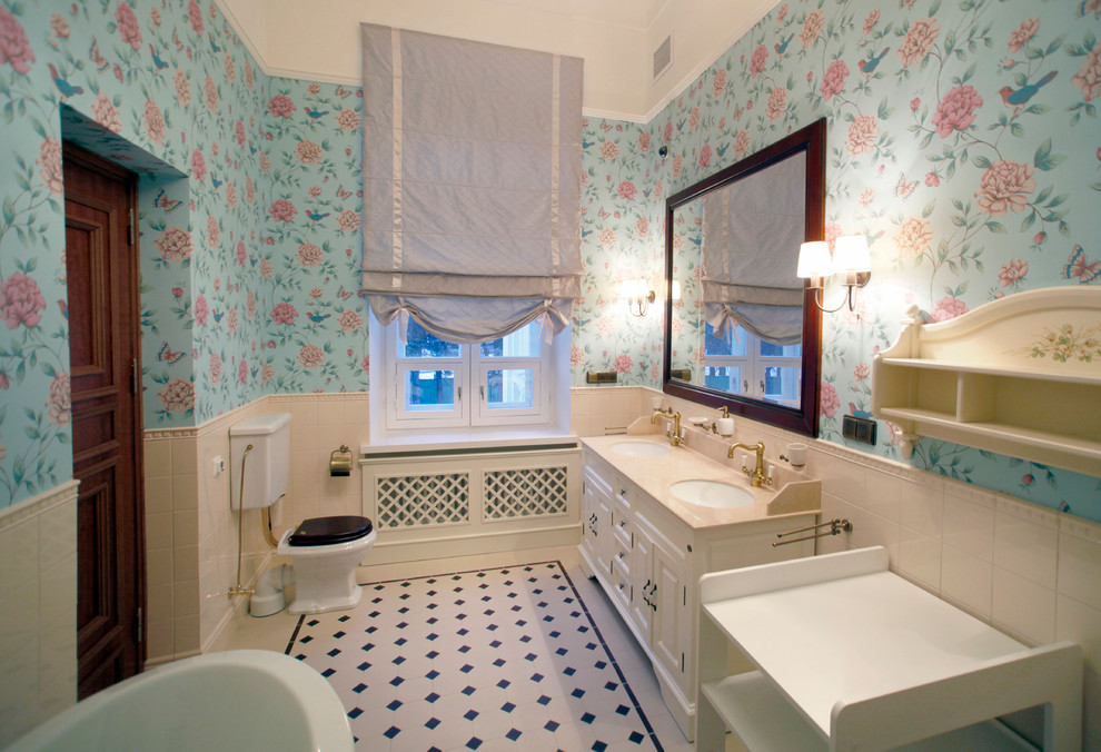 This is an example of a mid-sized traditional kids bathroom in Moscow with an undermount sink, furniture-like cabinets, beige cabinets, quartzite benchtops, a freestanding tub, a shower/bathtub combo, a one-piece toilet, beige tile, ceramic tile, blue walls and ceramic floors.