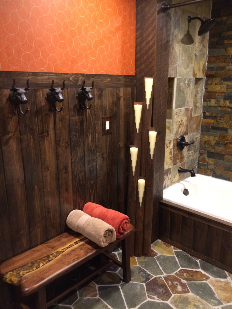 Mid-sized mountain style home design photo with a vessel sink, green cabinets, quartzite countertops, a two-piece toilet, orange walls and furniture-like cabinets