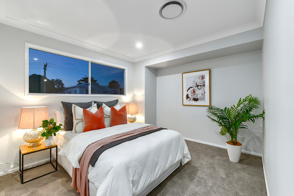 Design ideas for a beach style guest bedroom in Brisbane with grey walls, carpet and grey floor.