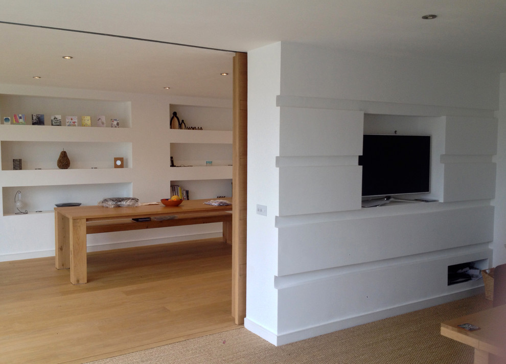 Custom built deep feature shelving with LED uplighters and built in TV